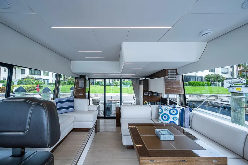 Slide: The Image of Luxurious interior of a 2021 Prestige 520 yacht with modern furnishings and large windows. - 64