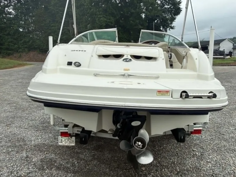 Slide: The Image of Rear view of a 2006 Sea Ray 200 SD boat on gravel. - 12