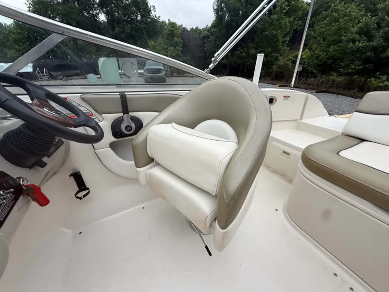 Slide: The Image of Interior of a 2006 Sea Ray 200 SD boat with steering wheel and seats. - 17