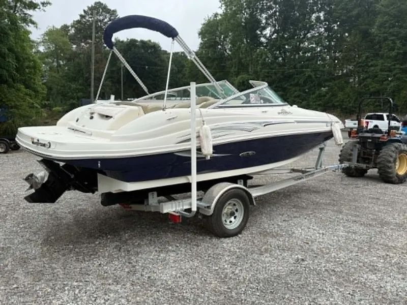 Slide: The Image of 2006 Sea Ray 200 SD boat on trailer parked outdoors. - 7