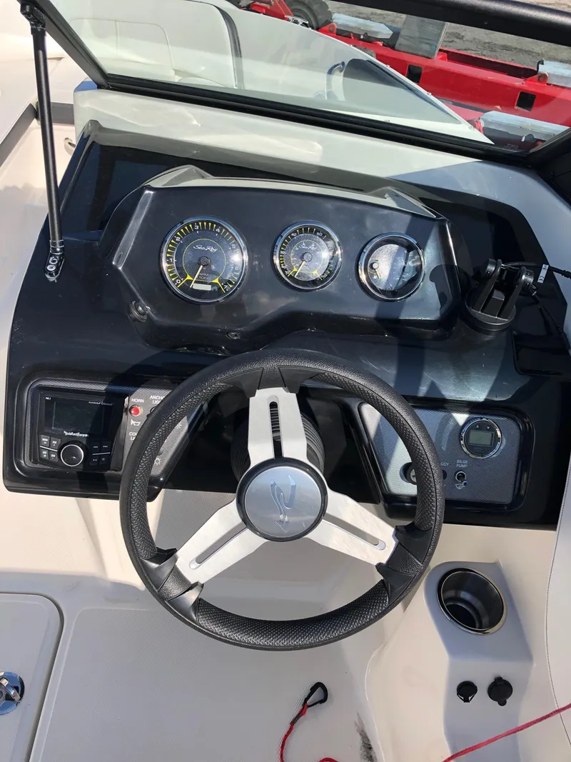 Slide: The Image of Dashboard of a 2017 Sea Ray 21 SPX boat with steering wheel. - 14