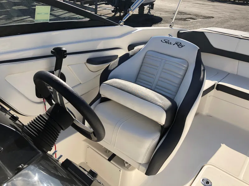 Slide: The Image of Interior of a 2017 Sea Ray 21 SPX boat with steering and seat. - 19