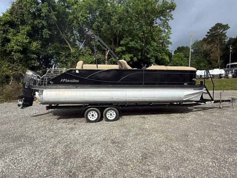 The Image of 2019 Manitou SES 230 pontoon boat on trailer, parked outdoors. - 1
