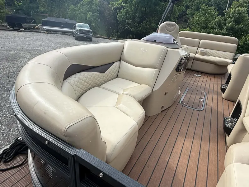 Slide: The Image of 2019 Manitou SES 230 pontoon boat with luxurious interior seating. - 10