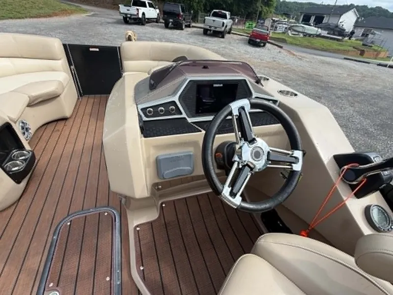 Slide: The Image of Interior of a 2019 Manitou SES 230 boat with steering wheel and dashboard. - 14