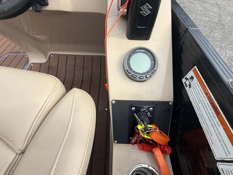Slide: The Image of Interior view of a 2019 Manitou SES 230 boat with control console. - 16