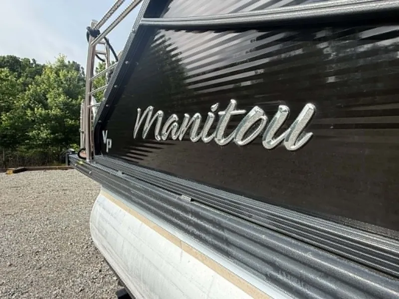 Slide: The Image of 2019 Manitou SES 230 pontoon boat parked outdoors. - 18