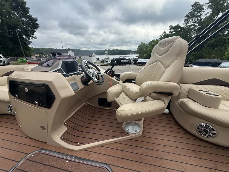 Slide: The Image of Interior of a 2019 Manitou SES 230 boat with luxurious seating. - 23