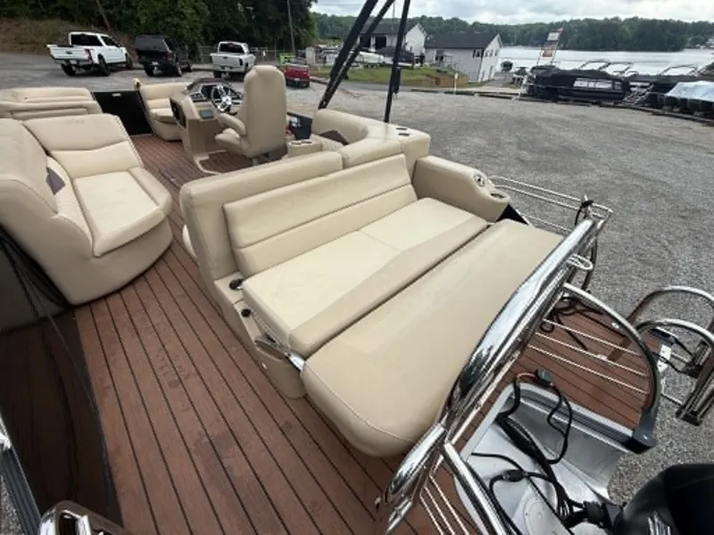 Slide: The Image of 2019 Manitou SES 230 pontoon boat with luxurious seating by the lake. - 24