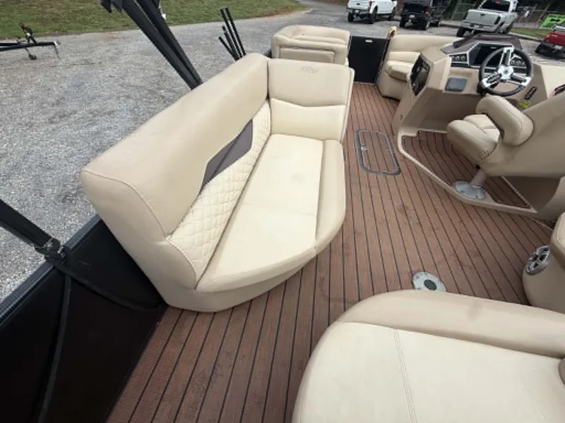 Slide: The Image of Interior of a 2019 Manitou SES 230 pontoon boat with beige seating. - 29