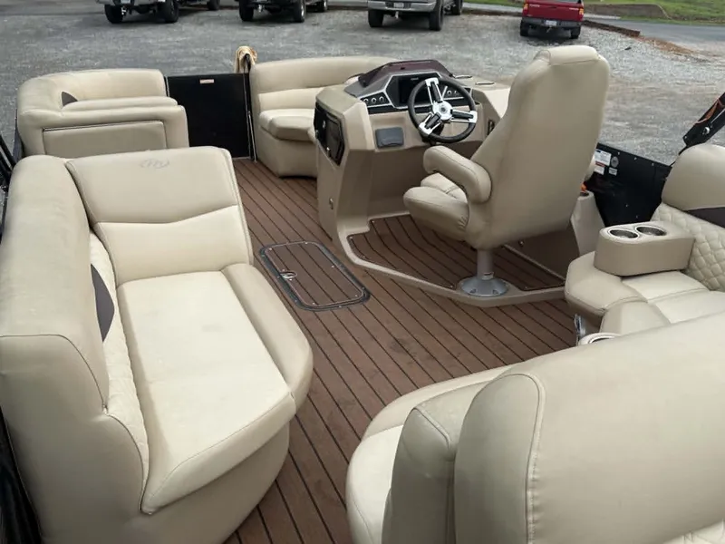 Slide: The Image of Interior of a 2019 Manitou SES 230 pontoon boat with beige seating. - 3