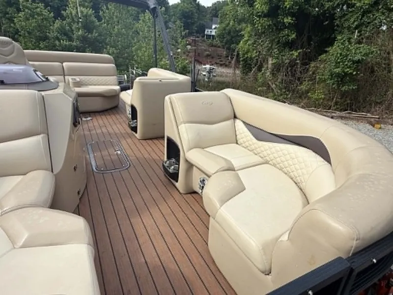 Slide: The Image of Interior of a 2019 Manitou SES 230 pontoon boat with beige leather seating. - 30
