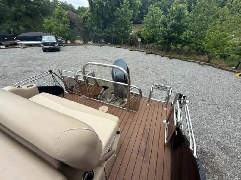 Slide: The Image of 2019 Manitou SES 230 pontoon boat parked on gravel lot. - 5