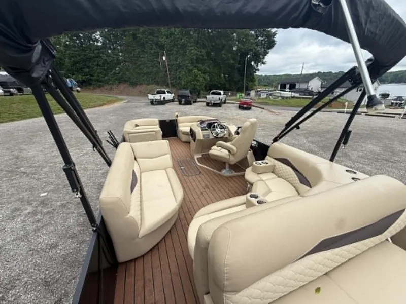 Slide: The Image of Interior view of a 2019 Manitou SES 230 pontoon boat with beige seating. - 8