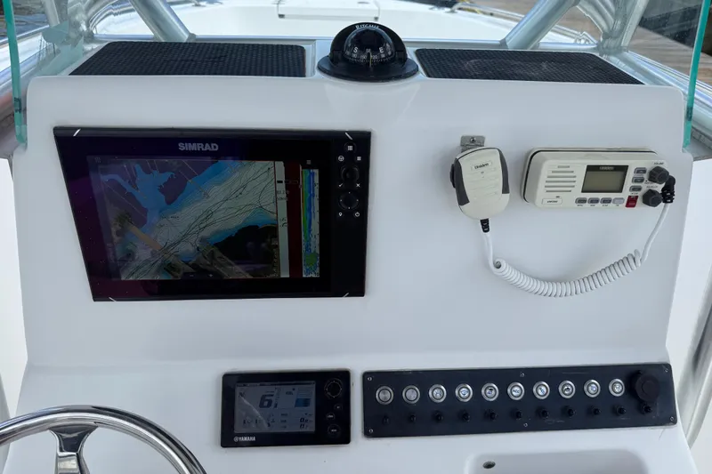 Slide: The Image of Dashboard of 2016 Cape Horn 22 OS with navigation and communication equipment. - 14