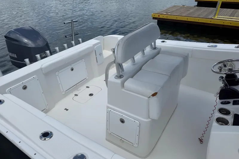 Slide: The Image of 2016 Cape Horn 22 OS boat interior with Yamaha engine, docked by the water. - 19