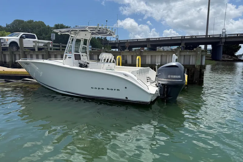 Slide: The Image of 2016 Cape Horn 22 OS boat docked with Yamaha outboard motor. - 2