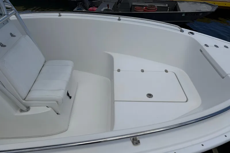 Slide: The Image of 2016 Cape Horn 22 OS boat interior with white seating and storage compartment. - 20