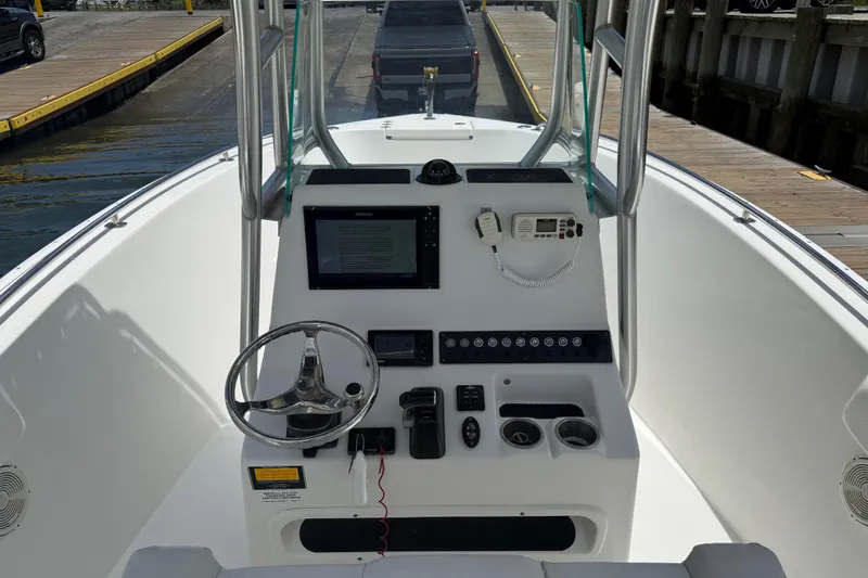 Slide: The Image of 2016 Cape Horn 22 OS boat dashboard with steering wheel and navigation equipment. - 23