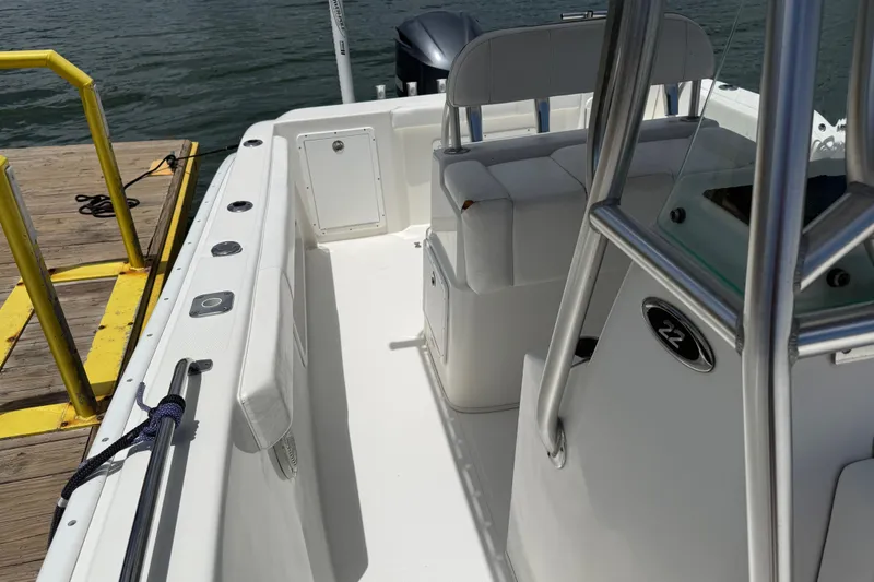 Slide: The Image of 2016 Cape Horn 22 OS boat interior at dock, showcasing seating and deck layout. - 32