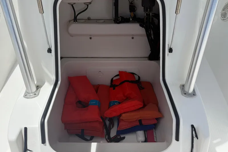 Slide: The Image of Storage compartment with life jackets on a 2016 Cape Horn 22 OS boat. - 33