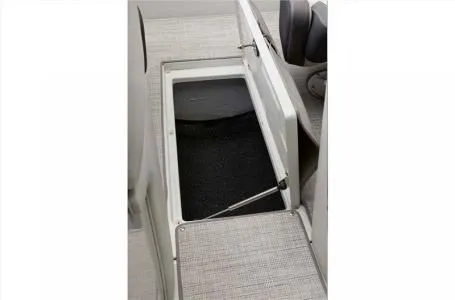 Slide: The Image of 2024 Crownline 200 SS boat storage compartment with open lid. - 12