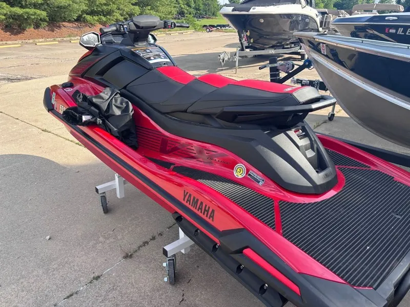 Slide: The Image of 2025 Yamaha VX Deluxe jet ski in vibrant red on a trailer. - 4