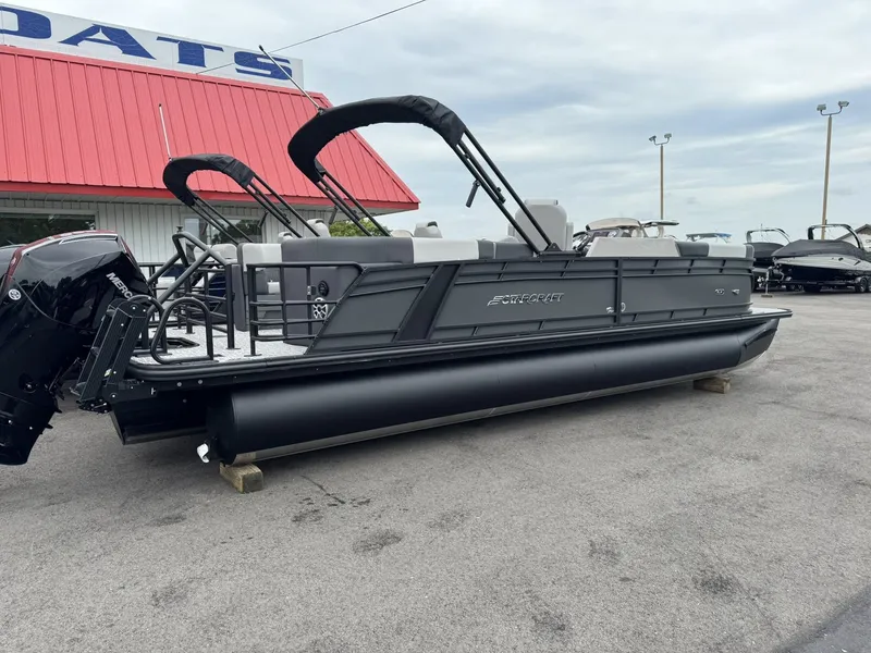 Slide: The Image of 2026 Starcraft SLS-5 R pontoon boat parked in front of red building. - 16