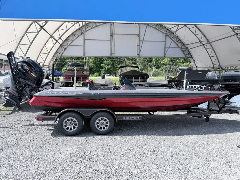 The Image of 2026 Skeeter ZXE21 boat on trailer under canopy. - 1