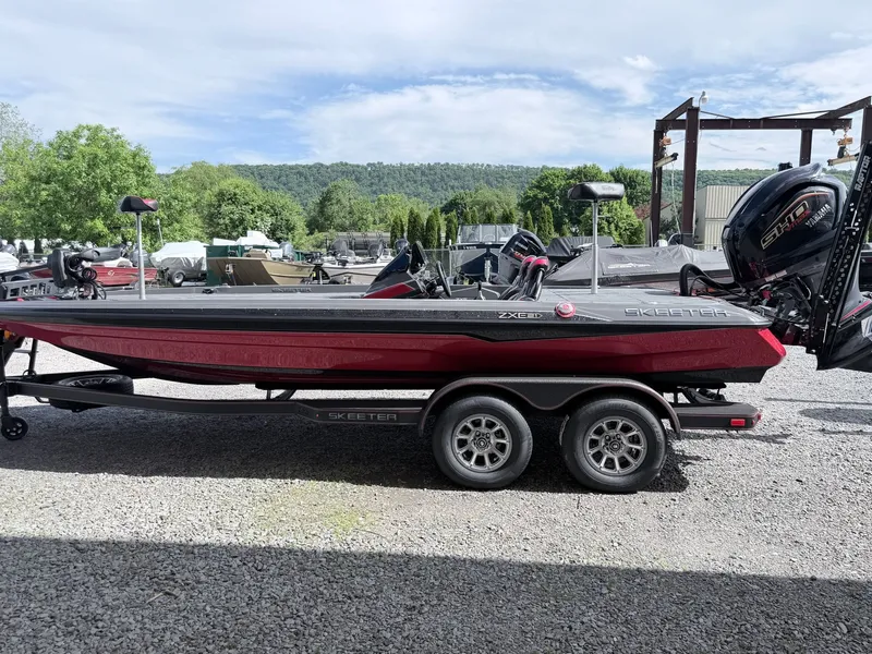 Slide: The Image of 2026 Skeeter ZXE21 boat on trailer, parked outdoors. - 23