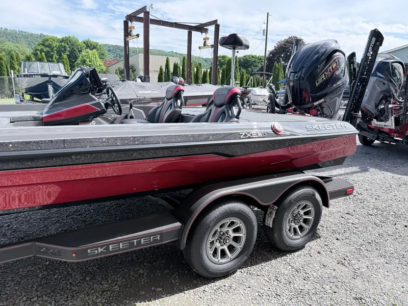 Slide: The Image of Skeeter ZXE21 2026 boat on trailer, red design, parked outdoors. - 4
