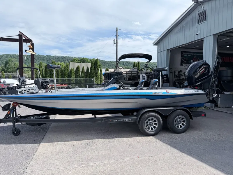 The Image of 2026 Skeeter ZXE20 boat on trailer outside workshop. - 1