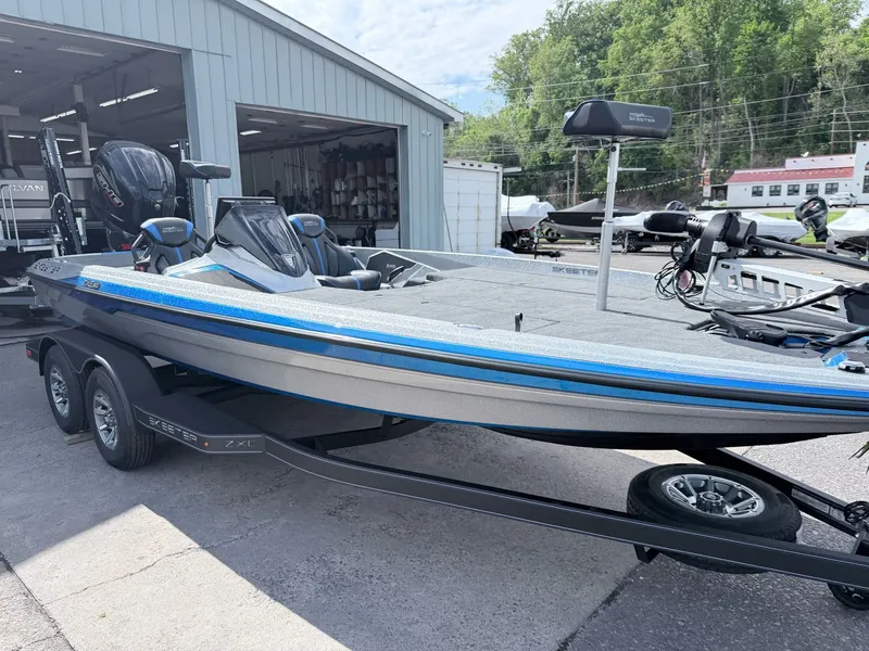 Slide: The Image of 2026 Skeeter ZXE20 boat on trailer outside workshop. - 18
