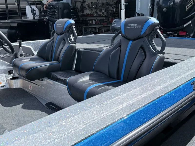 Slide: The Image of 2026 Skeeter ZXE20 boat with luxurious black and blue seats. - 19