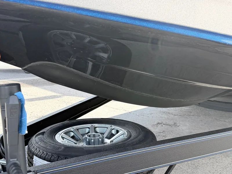 Slide: The Image of Skeeter ZXE20 boat hull above trailer tire, model 2026. - 20