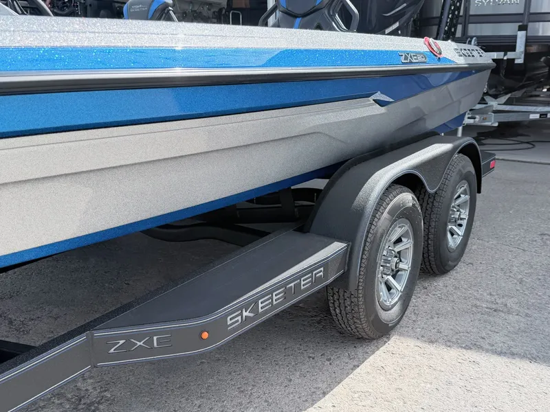 Slide: The Image of 2026 Skeeter ZXE20 boat on trailer, blue color. - 26