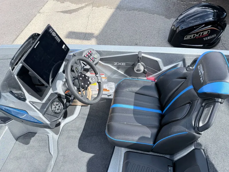 Slide: The Image of Interior of a 2026 Skeeter ZXE20 boat with steering and seat. - 32