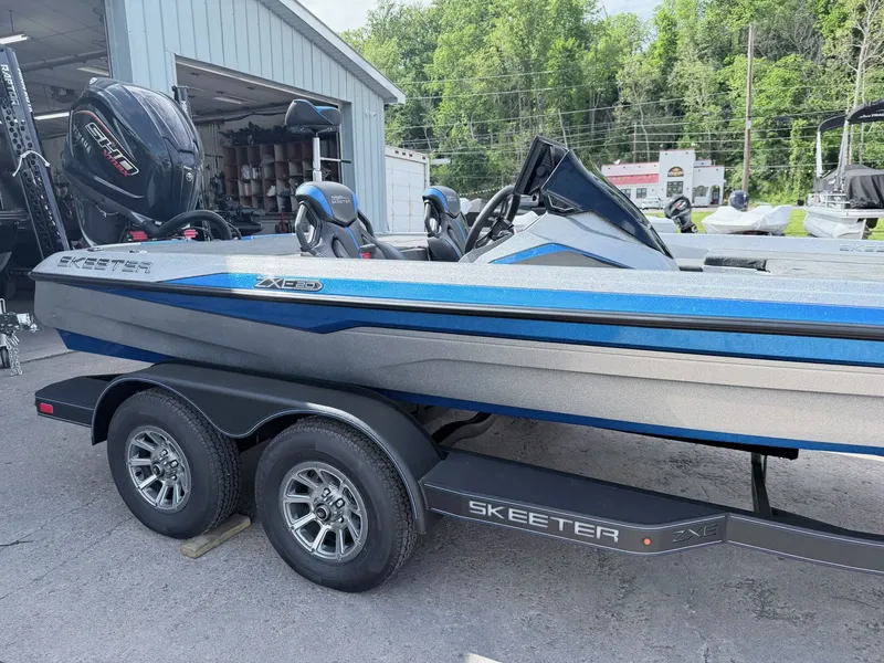 Slide: The Image of 2026 Skeeter ZXE20 boat on trailer, blue-gray design. - 35