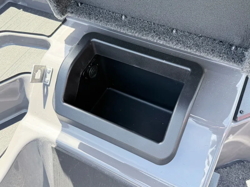 Slide: The Image of Skeeter ZXE20 2026 boat storage compartment with open lid. - 11