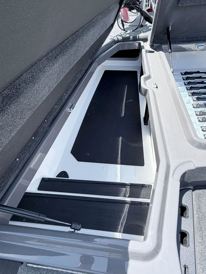 Slide: The Image of Skeeter ZXE20 2026 boat storage compartment with open lid. - 20