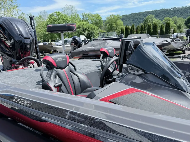 Slide: The Image of Skeeter ZXE20 2026 boat with modern seats and engine, parked outdoors. - 21