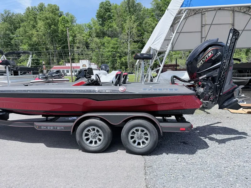 Slide: The Image of 2026 Skeeter ZXE20 boat on trailer, parked outdoors. - 23