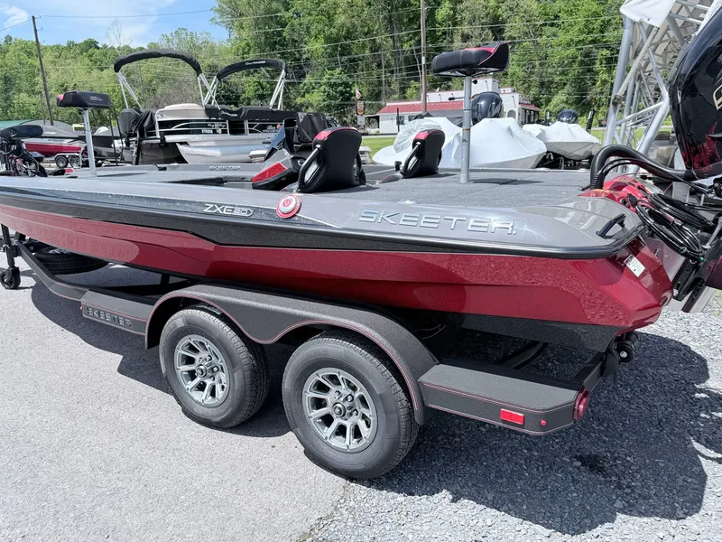 Slide: The Image of 2026 Skeeter ZXE20 boat on trailer, red and gray, parked outdoors. - 26
