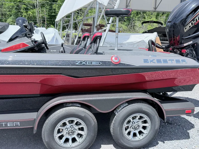 Slide: The Image of 2026 Skeeter ZXE20 boat with red and gray design on trailer. - 29