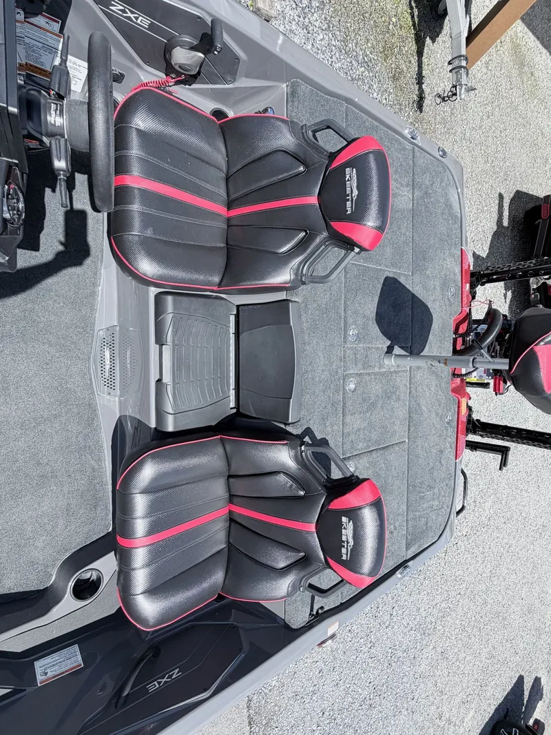 Slide: The Image of Interior of a 2026 Skeeter ZXE20 boat with black and red seats. - 37