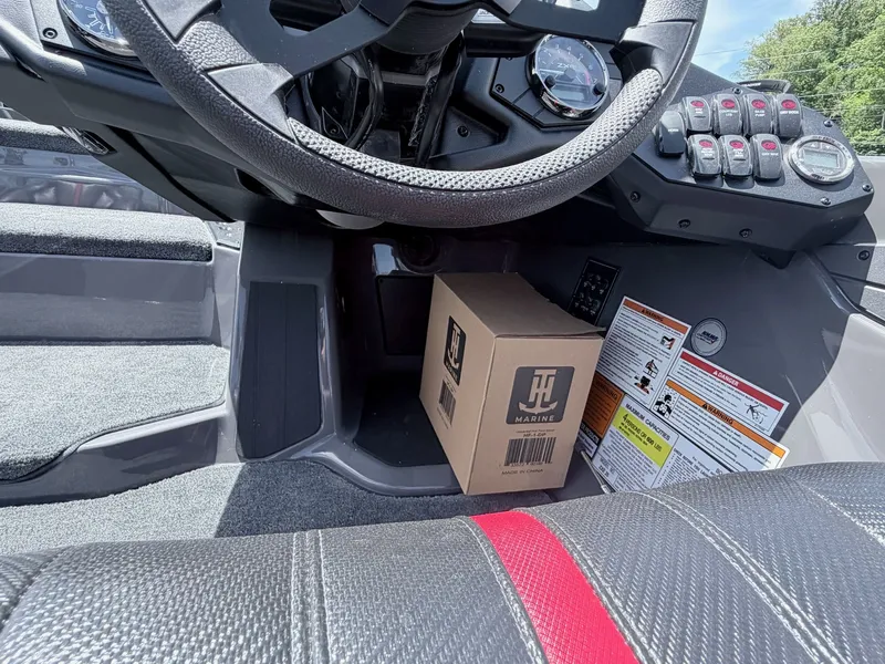 Slide: The Image of Interior of a Skeeter ZXE20 boat with steering wheel and box. - 4