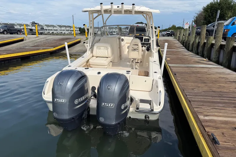 Slide: The Image of 2019 Grady-White Freedom 255 boat with twin Yamaha 150 engines docked at marina. - 10