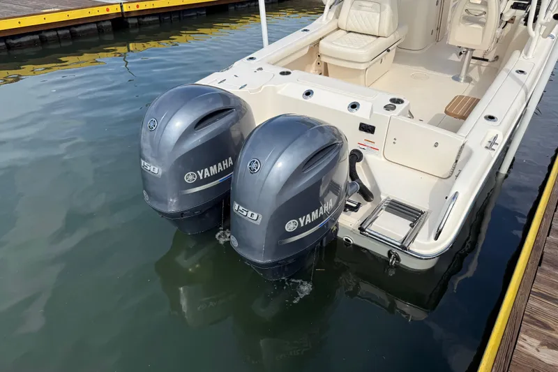 Slide: The Image of 2019 Grady-White Freedom 255 boat with twin Yamaha 150 outboard engines docked. - 11