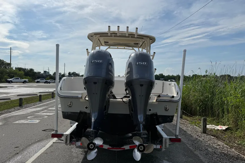 Slide: The Image of 2019 Grady-White Freedom 255 boat with twin 150 horsepower engines, parked on a trailer. - 13