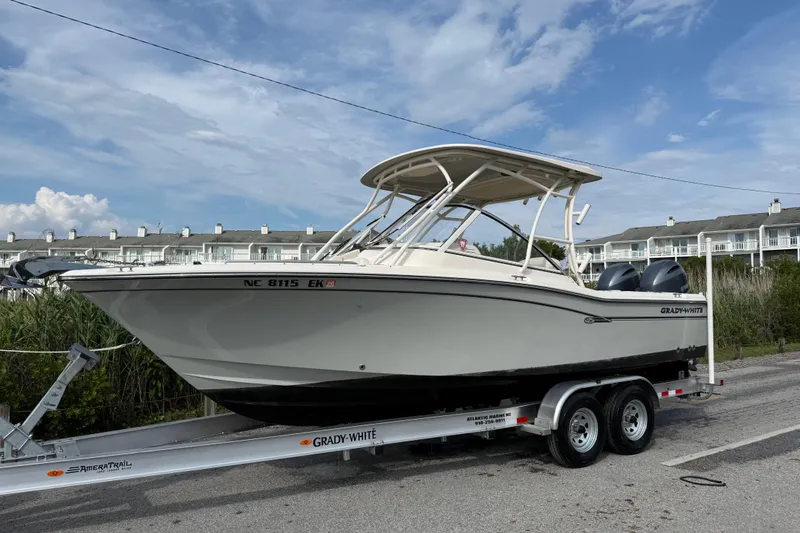 Slide: The Image of 2019 Grady-White Freedom 255 boat on trailer, parked near residential area. - 15